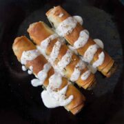 3 golden vegan borek with spinach filling and yoghurt drizzled over top