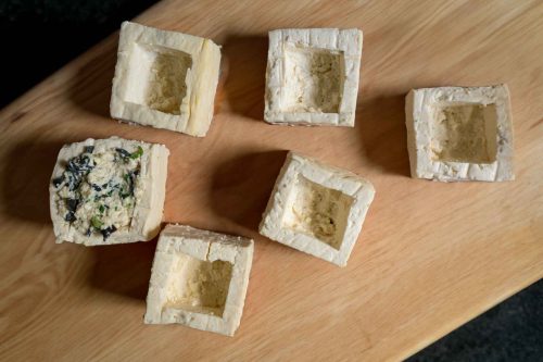 tofu with the middle carved out, awaiting filling