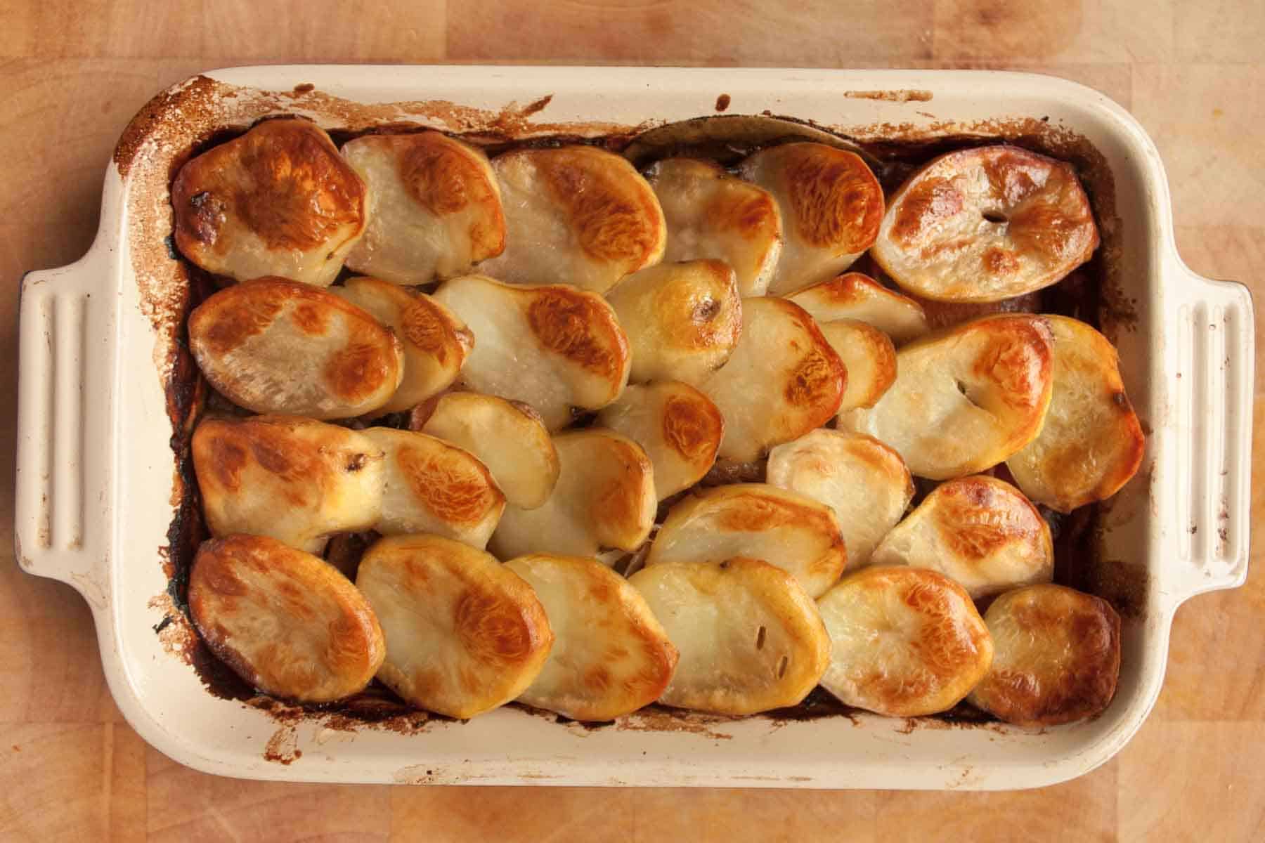 top down view of vegan lancashire hotpot, topped with crispy browned potatoes