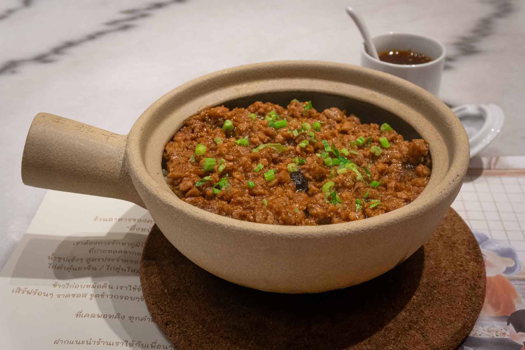claypot with vegan mince flecks of green herbs
