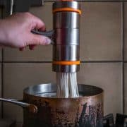 Cranking fresh noodles into boiling water