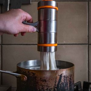 Cranking fresh noodles into boiling water