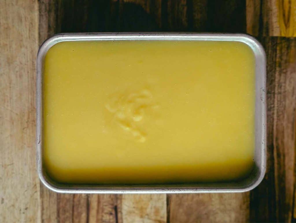 top down photo of a rectangular tray with yellow sweetcorn liang fen (starch jelly)